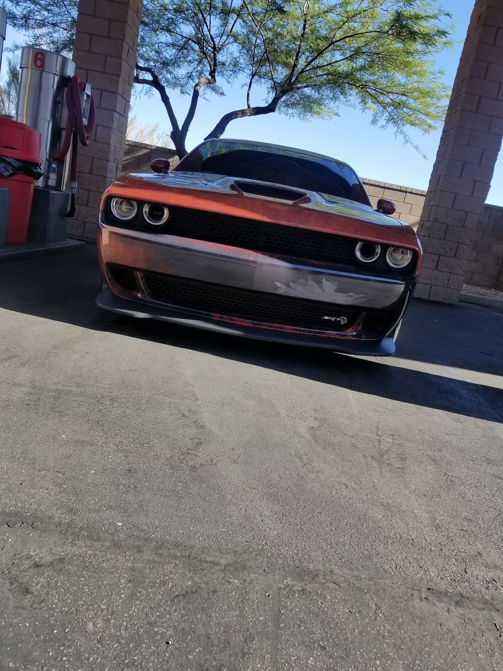 Dodge Challenger SRT Hellcat at a self-serve car wash bay